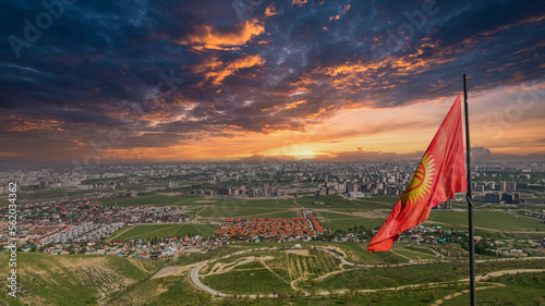 Flagpole with waving Kyrgyzstan flag and dramatic sky photo