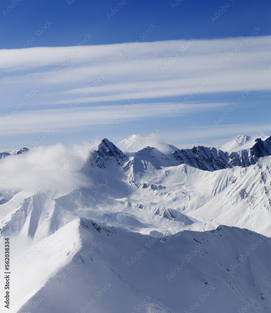 Naklejka premium Snow mountains in clouds