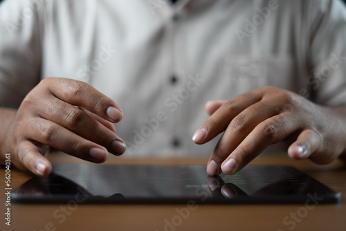 Man touching the tablet with both hands. background with a high tech concept