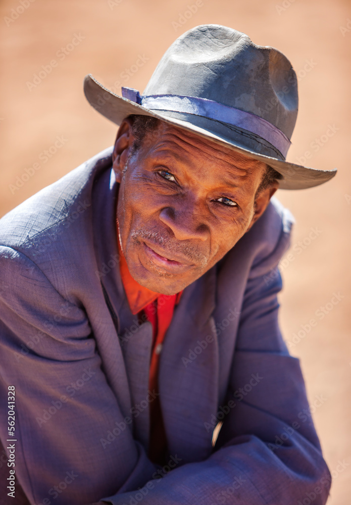 wrinkled african man with a hat in the village wrinkled african man with a hat in the village