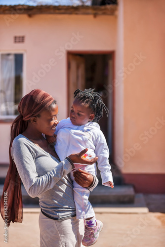 african woman with braids holding her baby © poco_bw