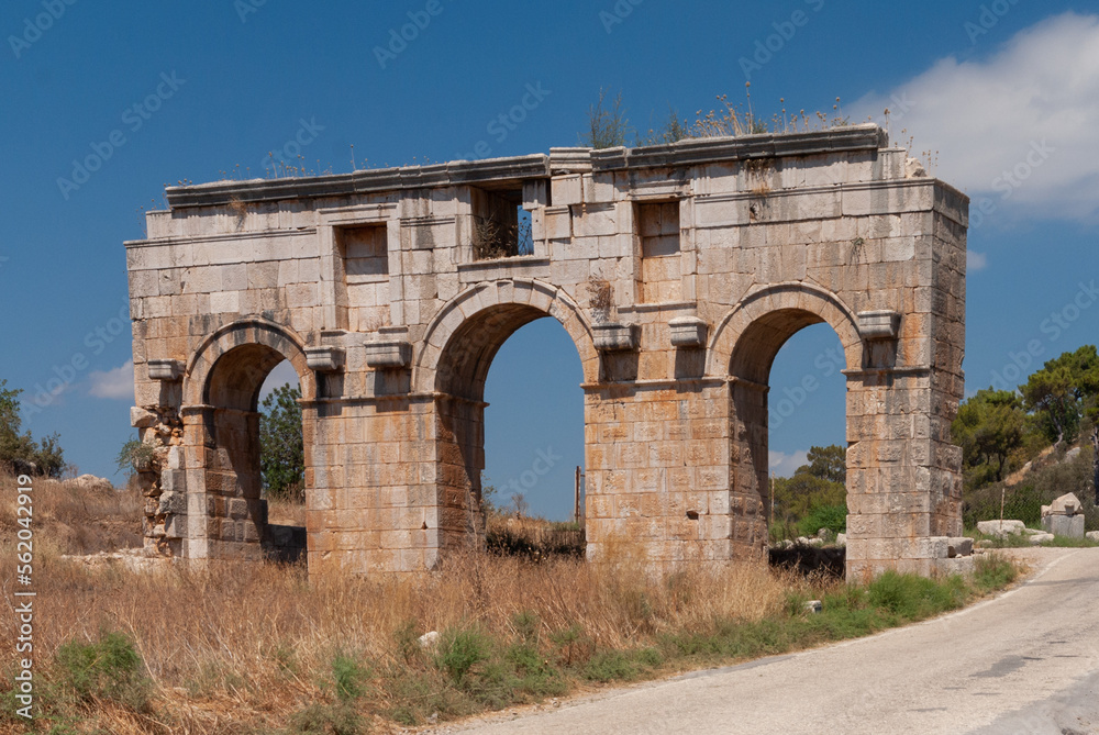 Turkey. Historical landmark. Ruins of ancient Roman temple. Temple of huge stones. Automobile road. Close-up. Mountain landscape. Clear sunny September day.