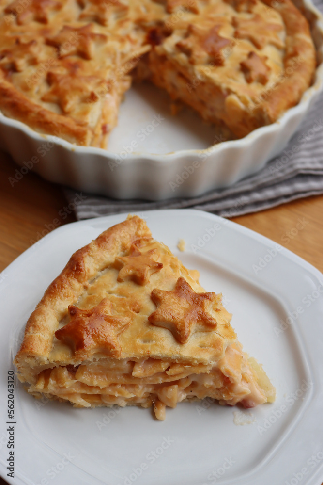 Cut Italian Timballo or Timbale filled with pasta and bechamel with tomato sauce on wooden table Cut Italian Timballo or Timbale filled with pasta and bechamel with tomato sauce on wooden table