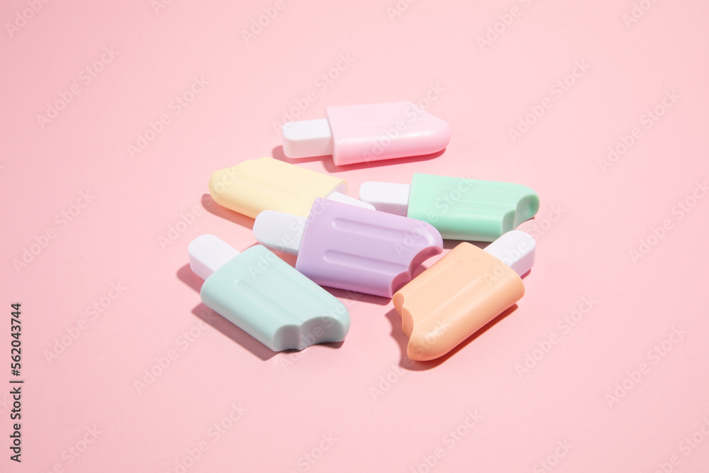Ice cream toys made from plastic on pink background with copy space Ice cream toys made from plastic on pink background with copy space