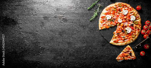 Sliced Mexican pizza with cherry tomatoes and rosemary.