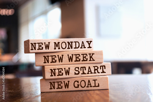 Wooden blocks with words 'New Monday, New week, new start, new goal'. photo