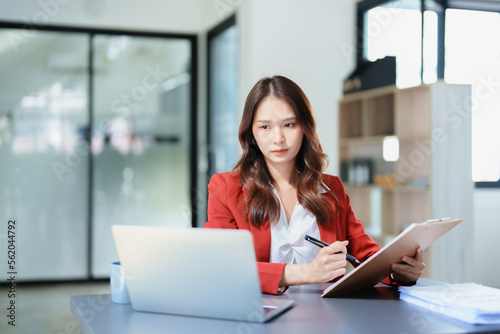 Free Download financial, Planning, Marketing and Accounting, portrait of Asian employee checking financial statements using documents and computer at work - GFXLoad