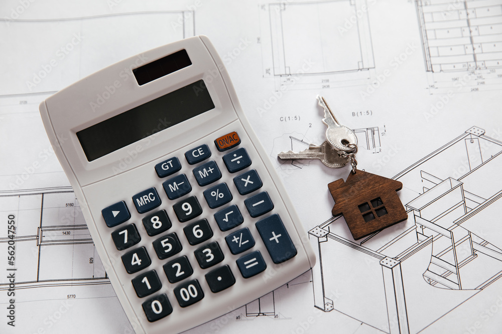 Model of house and calculator on design drawing. Building concept Model of house and calculator on design drawing. Building concept