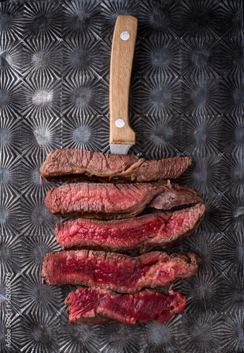 Different degrees of steak roasting. Steak with blood, medium to high roast steak on a wooden board photo