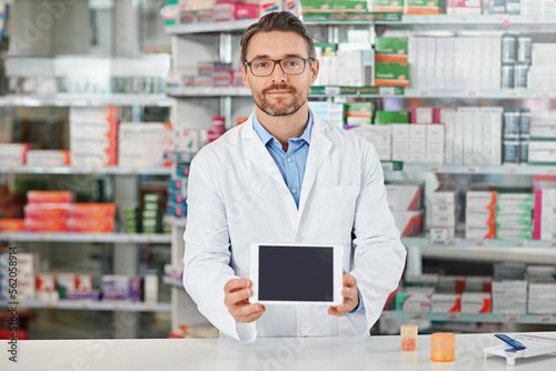 Pharmacist man, shop and portrait with tablet screen, focus and focus for marketing, medication or sales. Medical professional, pharma expert and mobile digital tech in pharmacy for wellness with app