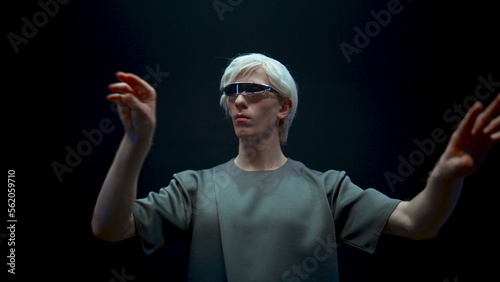 Closeup guy playing metaverse simulation in light. Futuristic millennial immerse