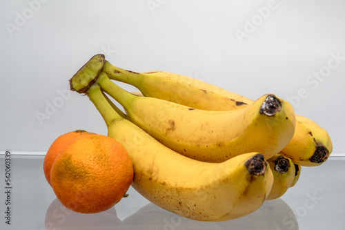 Fototapeta Naklejka Na Ścianę i Meble -  Bananas and tangerines in the fridge. Damaged and old fruit, fresh and healthy concept