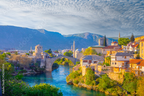 Fantastic Skyline of Mostar with the Mostar Bridge, houses and minarets, at sunset. Location: Mostar, Old Town, Bosnia and Herzegovina, Europe