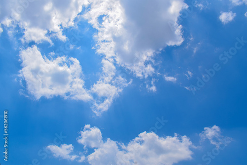 Deep blue skies with white clouds background  blue cloudy skies texture  dark blue sky wallpaper with with white fully clouds and sunlight.