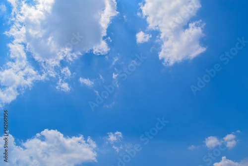 Deep blue skies with white clouds background, blue cloudy skies texture, dark blue sky wallpaper with with white fully clouds and sunlight.
