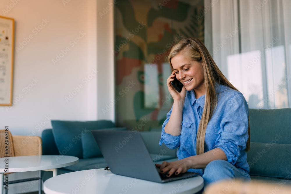 Happy woman talking to her client over the phone, typing something over the mobile phone. Happy woman talking to her client over the phone, typing something over the mobile phone.