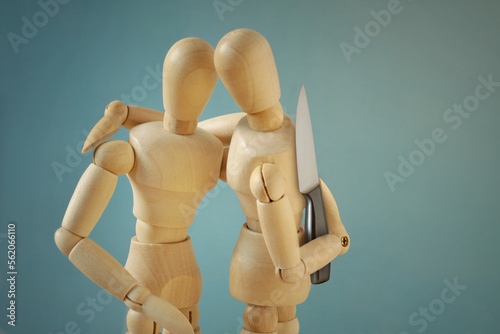 Canvas Print Wooden mannequins hugging each other with knife behind back - Concept of betraya