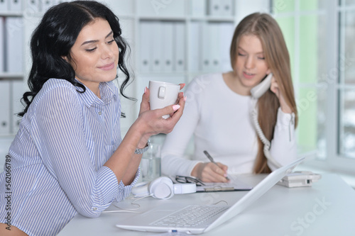 Young cute businesswomen working in modern office