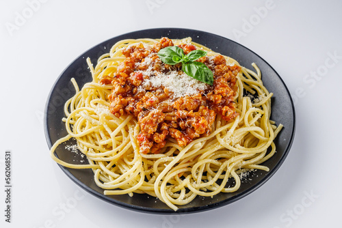 delicious Bolognese pasta on a black plate