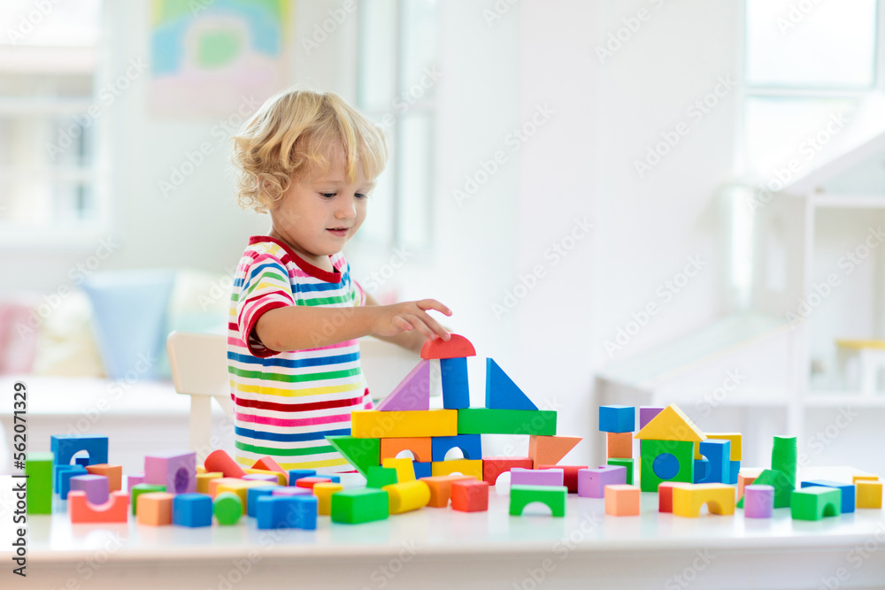 Kids toys. Child building tower of toy blocks. Kids toys. Child building tower of toy blocks.