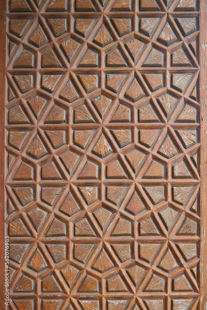 Decorative panel with wood carvings in an ancient oriental palace Decorative panel with wood carvings in an ancient oriental palace