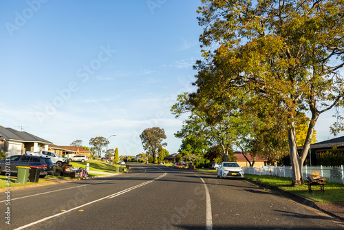 quiet street in town with piles of rubbish during curb side clean-up photo