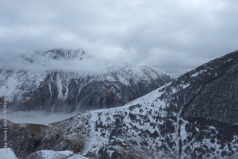 Obraz premium Georgian mountains. Kazbegi. Snow hills, epic clouds