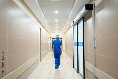Female doctor walking along a corridor in the hospital