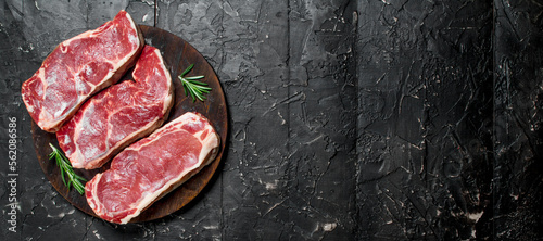 Raw beef steaks on cutting Board.