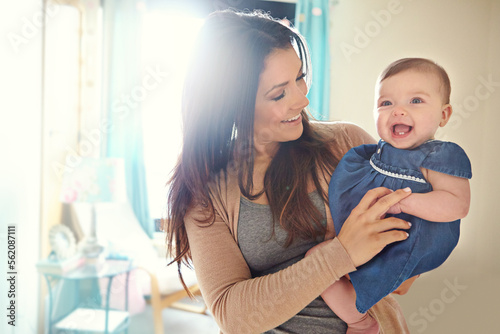 Mother, bonding or laughing baby girl in house living room or family home bedroom in support trust, security or love carrying. Smile, infant or happy mom holding child in funny or comic tickling game