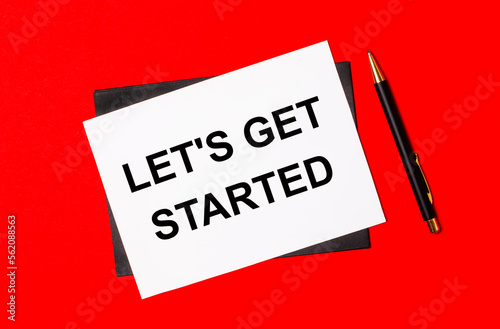 Black pen, envelope and white card with the text LET'S GET STARTED on a bright red background