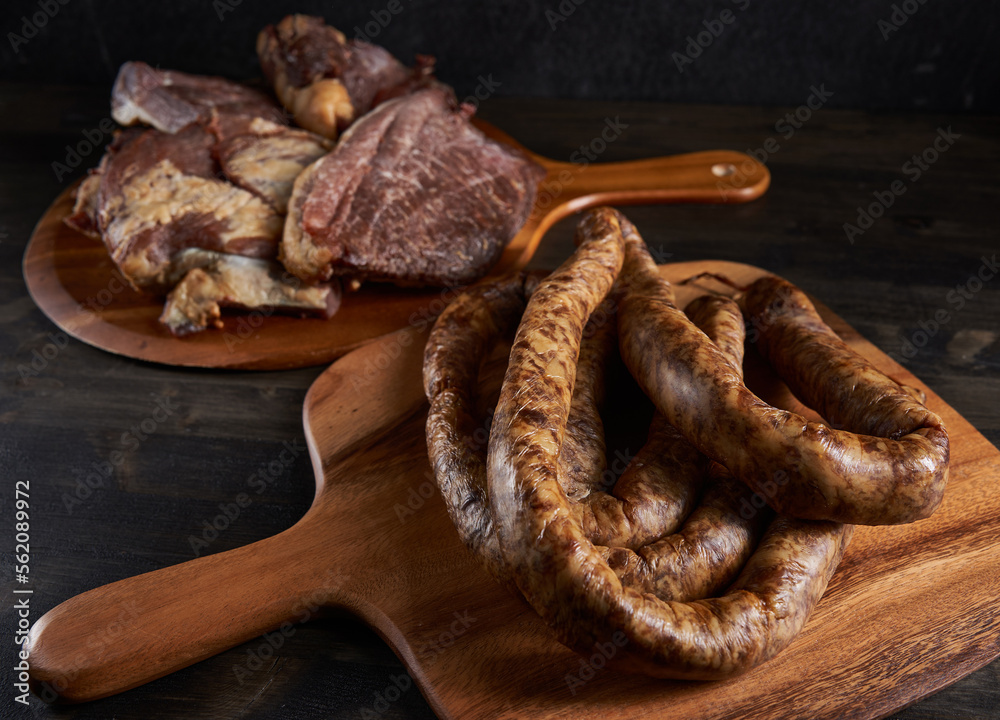 Smoked pork and sausage on wooden board Smoked pork and sausage on wooden board
