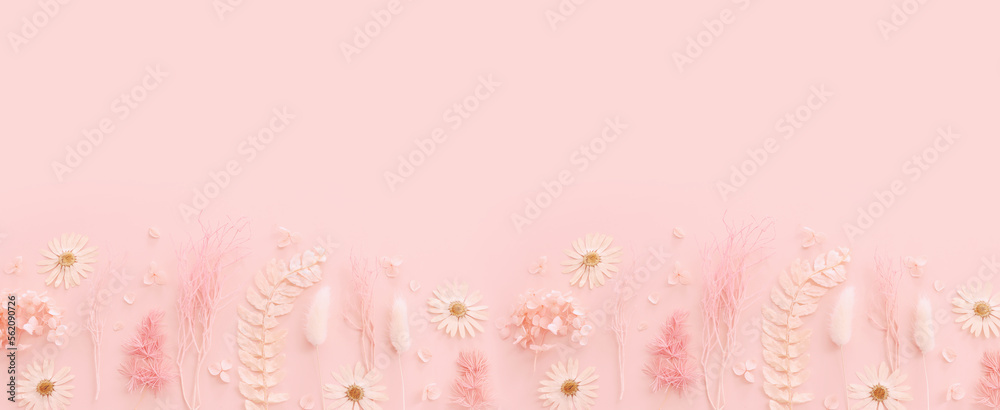 Fototapeta premium Top view image of pink dry flowers over pastel background .Flat lay