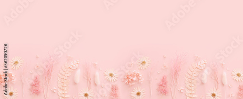 Top view image of pink dry flowers over pastel background .Flat lay © tomertu