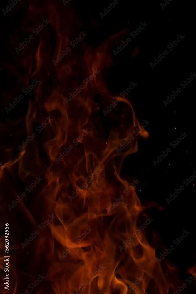 Fototapeta premium fire flames with sparks on a black background.