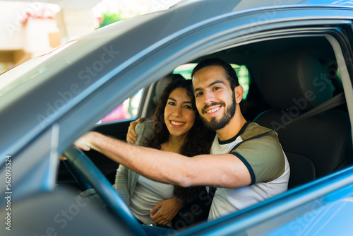 Attractive couple embracing while driving