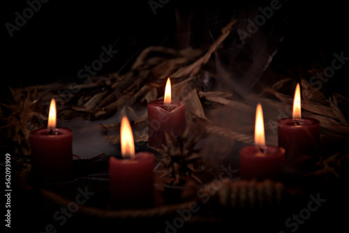 Pentagram amulet and black candle in autumn forest  natural background. Magic esoteric witches ritual. Mysticism  divination  wicca  occultism  witchcraft concept. Samhain sabbat.