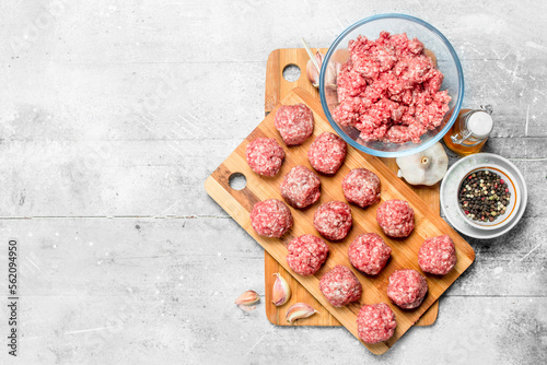 Raw meatballs made from fresh minced meat with spices .