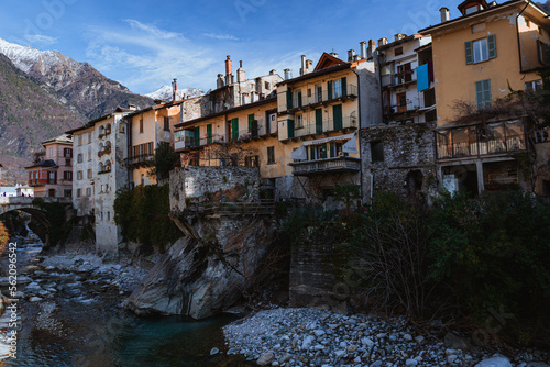 The riverside of the town of Chiavenna (Lombardy, Italy) with its historic houses and the mountains in the background, during a winter afternoon - January 2023. © Roberto
