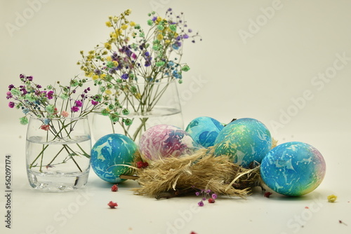 easter eggs in basket with flowers