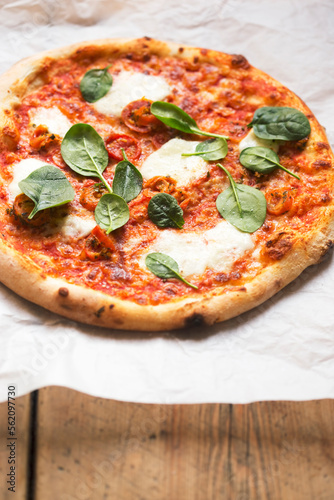 Pizza with tomato sauce, mozzarella and spinach 