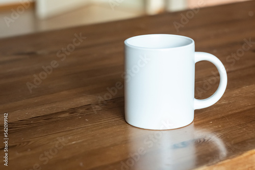 White mug on the wooden table.