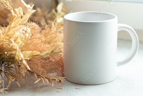 A white mug on the windowsill next to ekiban