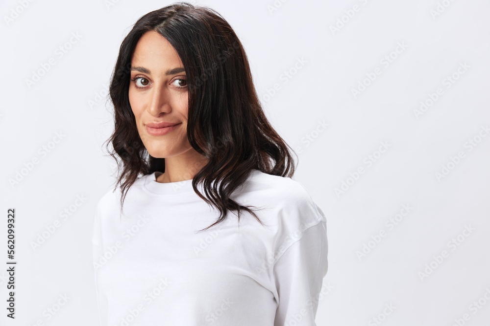 Woman in white t-shirt on white background brunette hands up gestures and signals poses in jeans emotion, lifestyle smiles, copy space