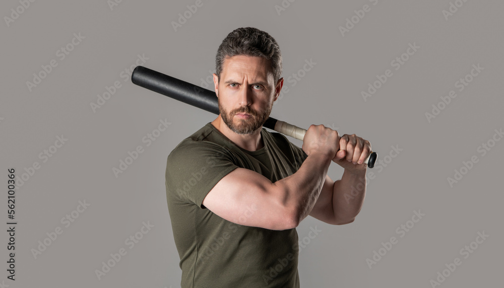 angry man express anger beating with bat isolated on grey background. aggression of angry man angry man express anger beating with bat isolated on grey background. aggression of angry man