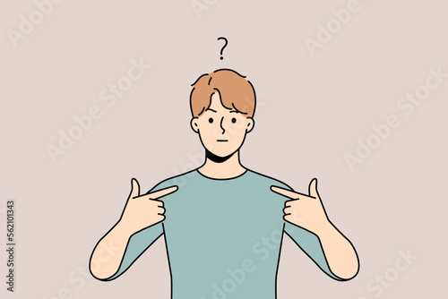 Frustrated young man feel confused point at himself. Unhappy guy feeling anxious showing with finger at him. Confusion and frustration. 