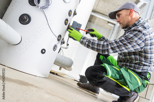 Professional HVAC Technician Contractor Finishing Hot Boiler Installation photo