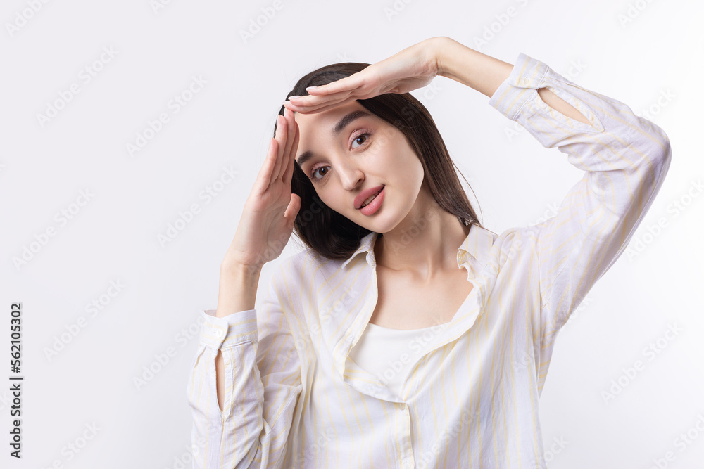Portrait of a serious young woman showing stop gesture with her palm over white background Portrait of a serious young woman showing stop gesture with her palm over white background