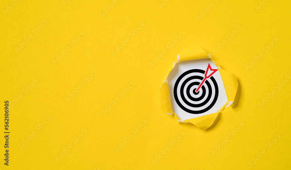 Dartboard with arrow inside of yellow punched paper for setup business objective target and goal concept. - obrazy, fototapety, plakaty 