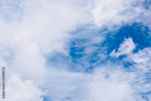 White fluffy clouds on beautiful clearly deep blue sky in a sunny day © Weerawich